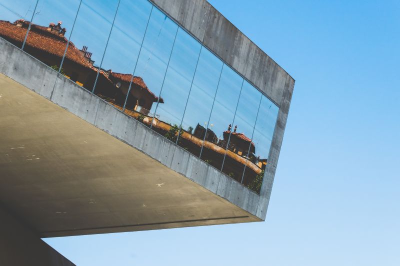 gray building with mirror glass windows at daytime.jpg